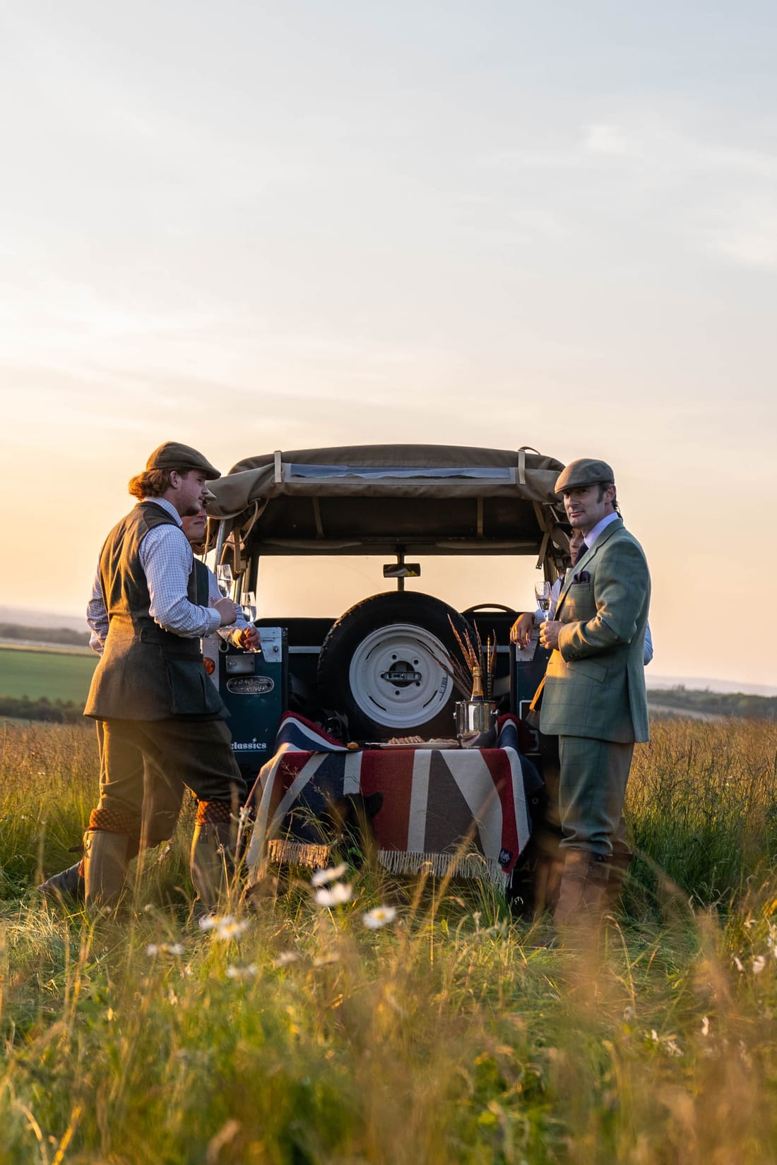 Detail shot from the Dege & Skinner campaign — tweeds, gun cases and the EV Classics Series 3 spare wheel